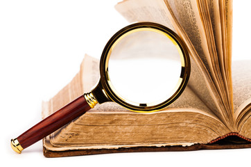 old book and magnifying glass isolated on white