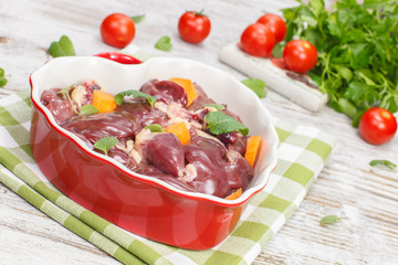 Raw chicken liver in heart shaped bowl