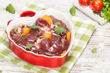 Chicken liver. Raw chicken liver in heart shaped bowl.