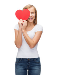 Fototapeta na wymiar smiling woman in blank white t-shirt with heart