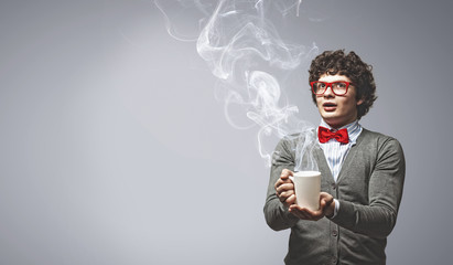 Young man with smoke coming out of cup