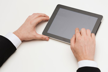 close up of man hands touching tablet pc
