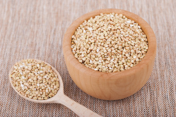 Plate with buckwheat on the tablecloth.