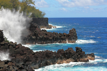 Ocean waves along the lava rock shore of Hawaii