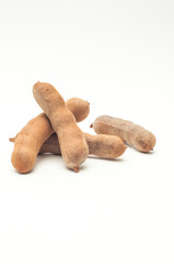 Ripe tamarind fruit on white background