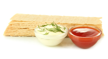 Potato chips and sauces, isolated on white