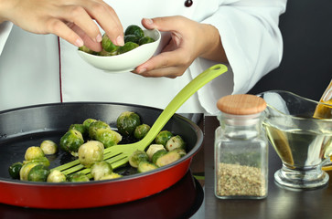 Chef prepares frresh brussels sprouts in pan