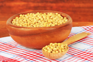Soy beans on table on wooden background