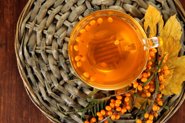 Branches of sea buckthorn with tea