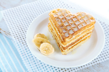 Sweet Belgium waffles with banana, isolated on white