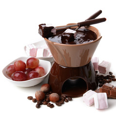 Chocolate fondue with marshmallow candies and fruits, isolated