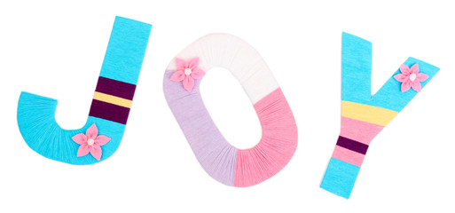 Word Joy created with brightly colored knitting yard isolated