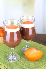 Dessert of chocolate and persimmon on table on light background