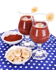 Cocktails with banana and chocolate on table on white