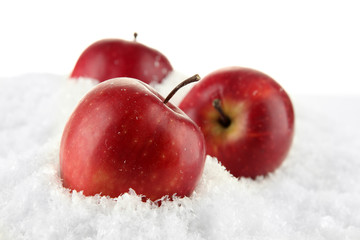 Red apples in snow isolated on white © Africa Studio