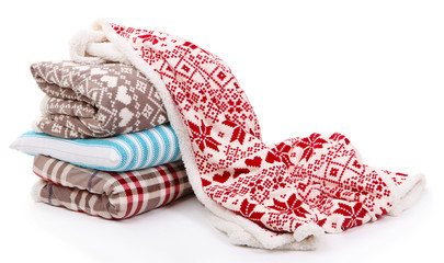 Warm plaids and pillows isolated on white