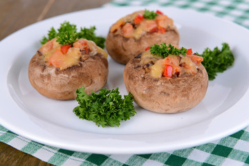 Stuffed mushrooms on plate on table close-up