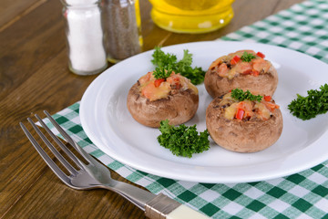 Stuffed mushrooms on plate on table close-up
