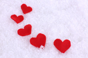 Fototapeta premium Little felt hearts on snowy background