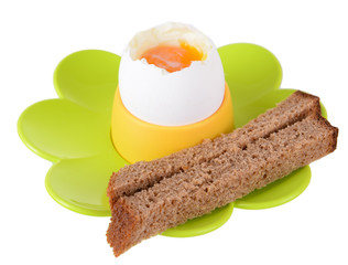 Boiled egg in egg cup isolated on white