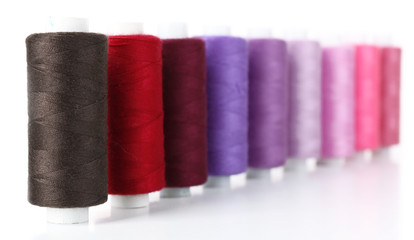 Colored spools of threads isolated on white