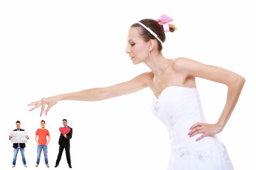 Fototapeta premium Young woman in wedding dress choosing candidate for husband