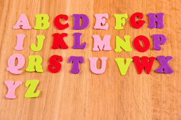 English alphabet on wooden background