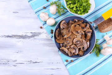 Delicious fried mushrooms in pan on table close-up