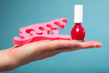 foot pedicure red nail polish and toe separators