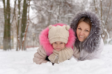 Mother and daughter  in the snow.