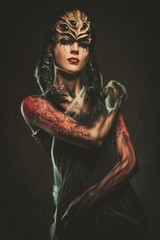 Young woman with spider body art and mask