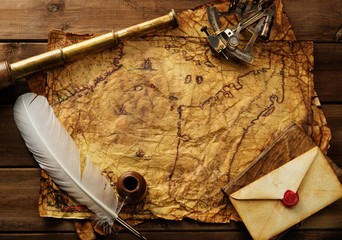 Sextant, spyglass and envelope on vintage map 