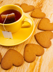  cup with tea bag and heart-shaped cookies