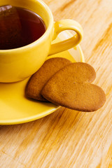  cup with tea bag and heart-shaped cookies