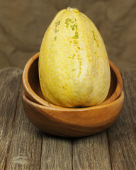 Big marrow squash  in bowl on wooden background.