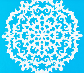 white snowflake on blue paper