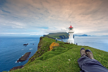 Resting after hiking at Mykines Lighthouse, Faroe Islands - 60268030