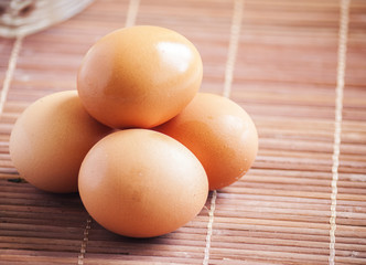 fresh eggs on wooden background close up