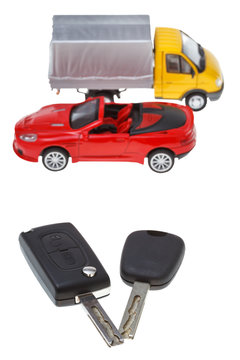 two vehicle keys and model truck and car