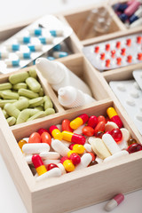 medical pills and ampules in wooden box