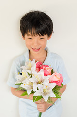 Obraz na płótnie Canvas Asian boy holding flower bouquet on white background