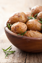 baked potatoes in wooden bowl