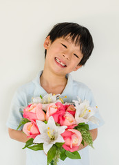 Asian boy holding flower bouquet on white background