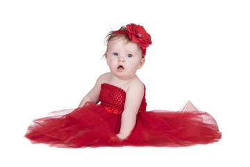 baby in red dress and red flower on the head