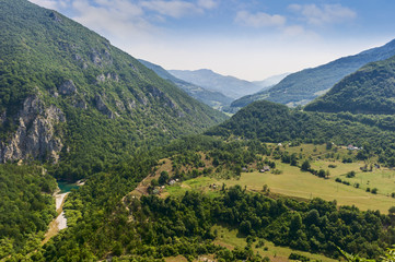 Obraz premium village in the valley of low mountains