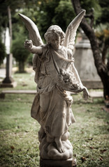 Statue of angel in old cemetery Museum Prasasti