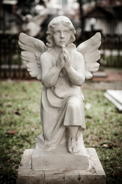 Statue of angel in old cemetery Museum Prasasti