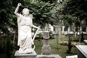 Statue of angel in old cemetery Museum Prasasti