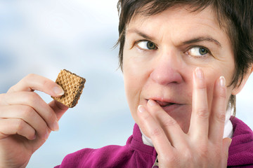 Woman eating cookie