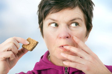 Woman eating cookie